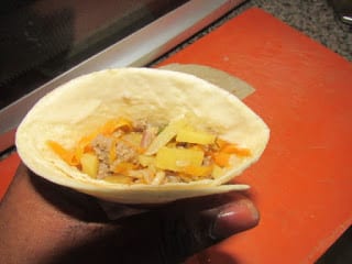 Scoop stir fry into cut and folded tortilla